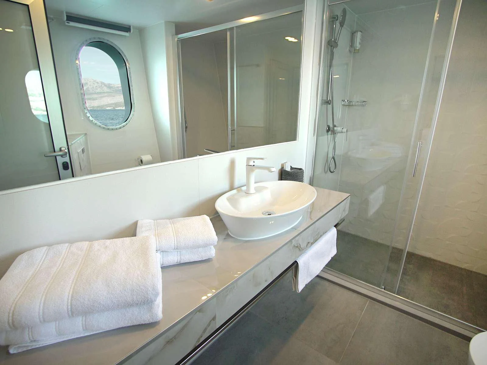 a bathroom with a sink and a mirror aboard OHANA Yacht for Sale