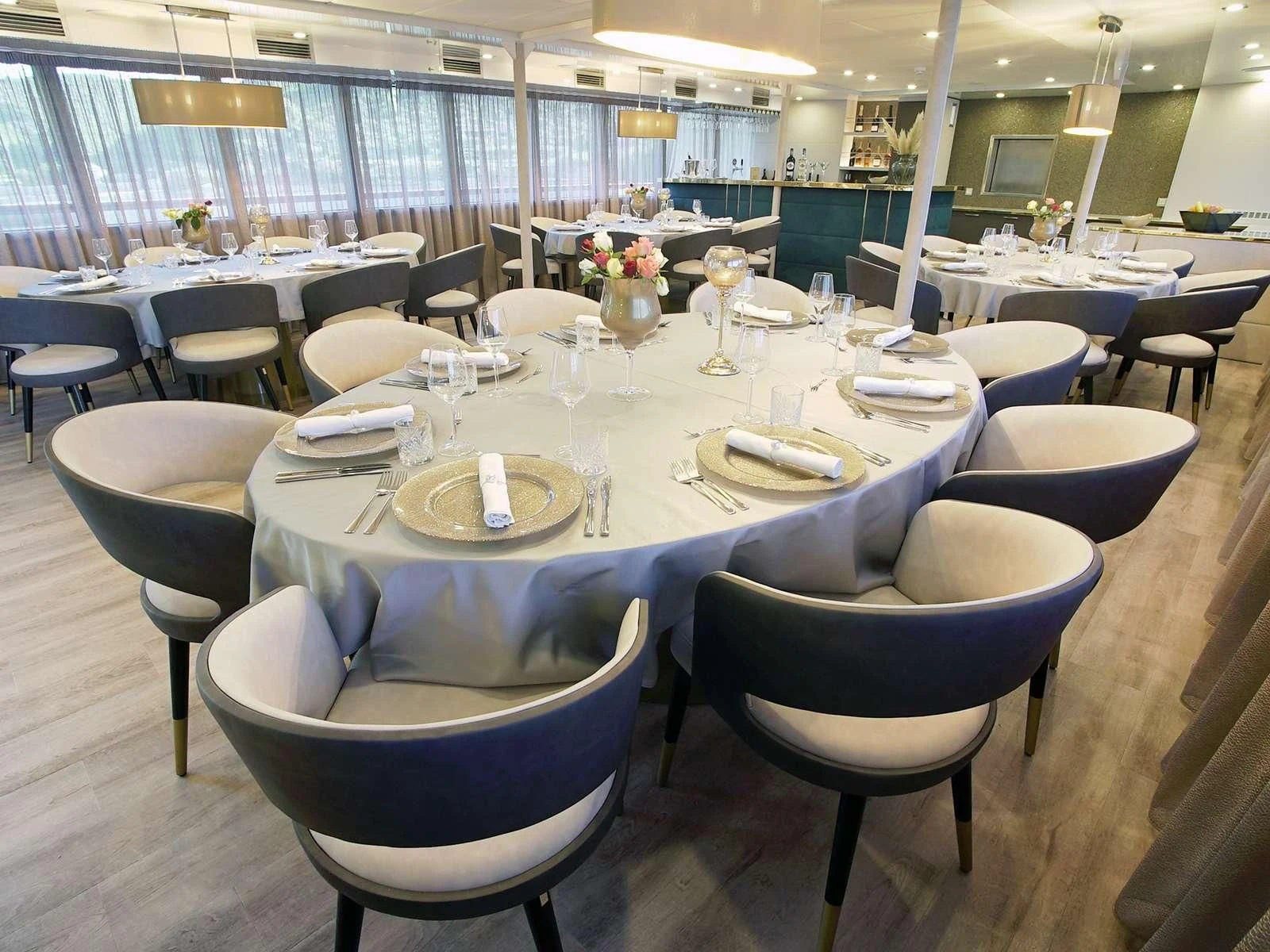 a room with tables and chairs aboard OHANA Yacht for Sale