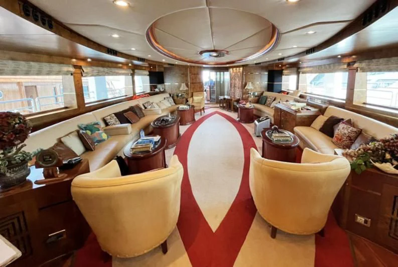 a large room with a large table and chairs aboard NASAYEM Yacht for Sale