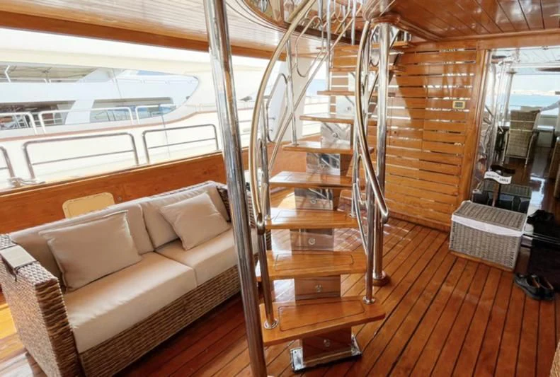 a room with a couch and a ladder aboard NASAYEM Yacht for Sale