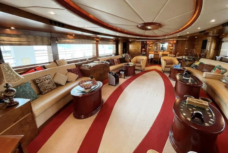 a living room with a large red rug aboard NASAYEM Yacht for Sale