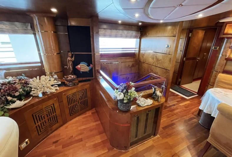 a room with a table and chairs aboard NASAYEM Yacht for Sale