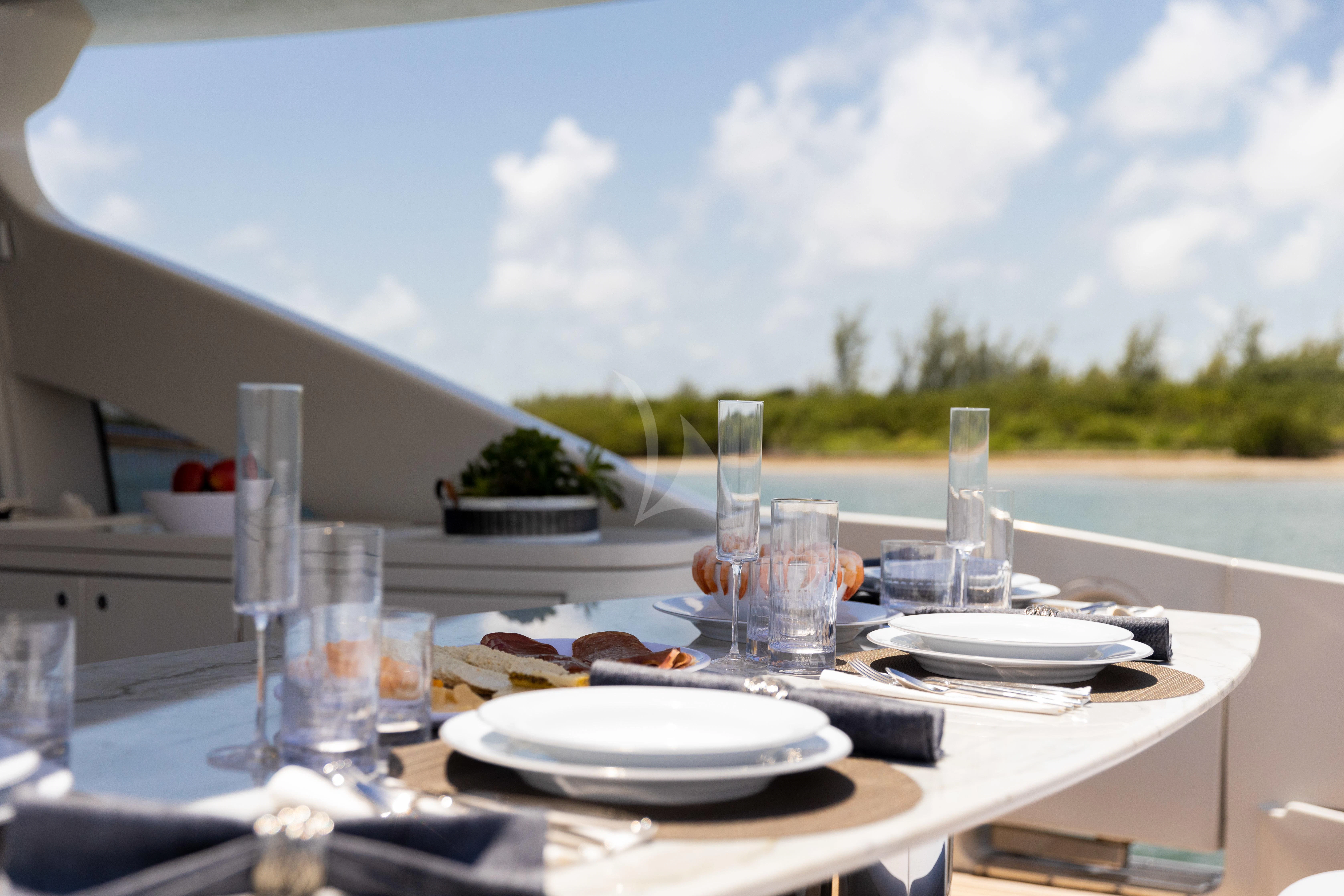 a table with plates and glasses on it aboard M Yacht for Charter