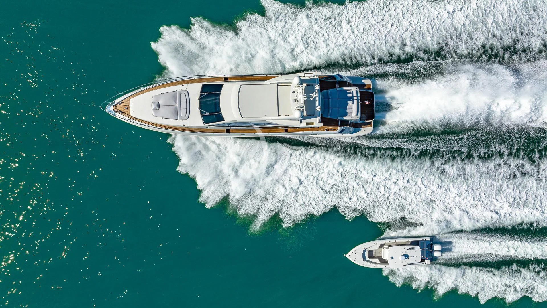 a helicopter flying over a beach aboard M Yacht for Charter