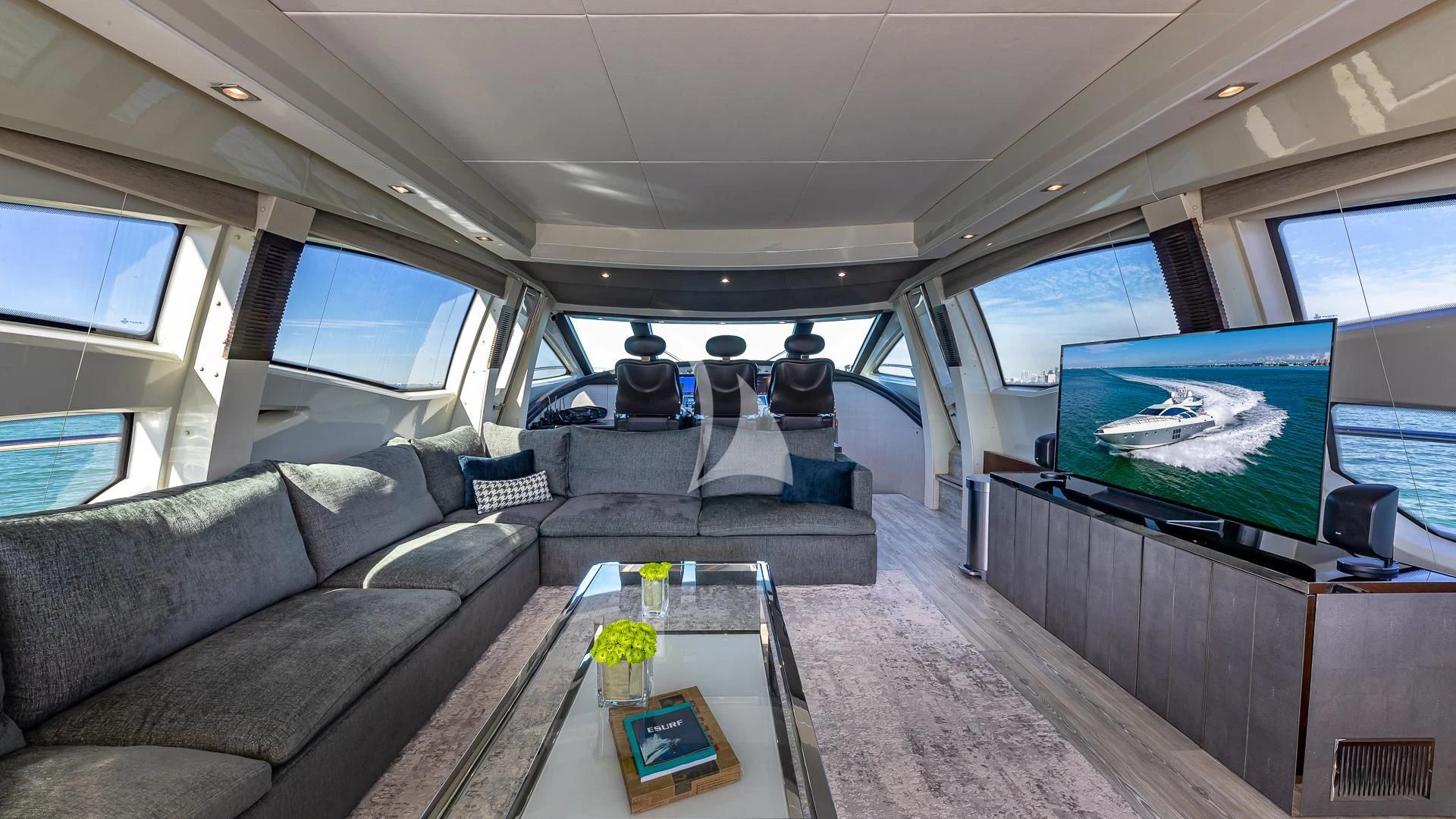 inside of a vehicle with a table and a tv on the wall aboard M Yacht for Charter