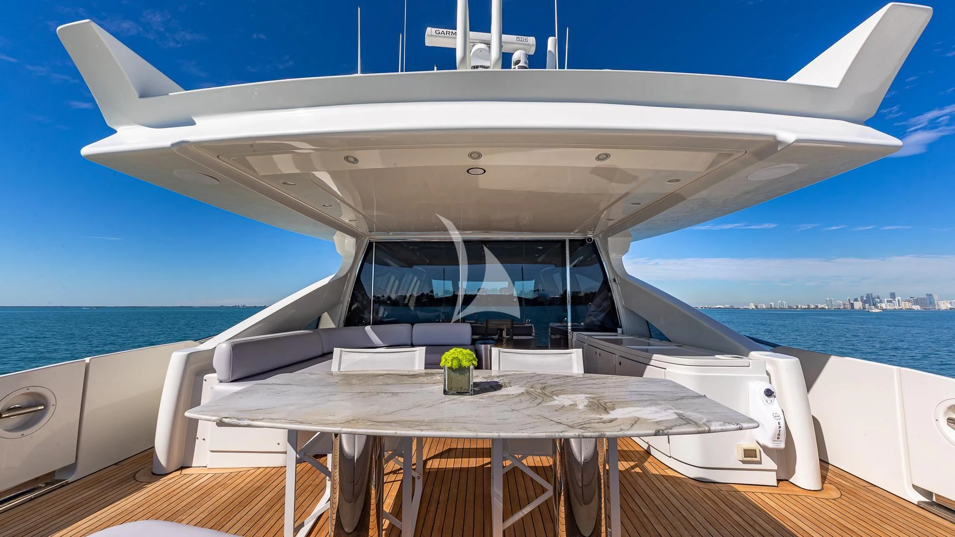 a white boat on a deck aboard M Yacht for Charter