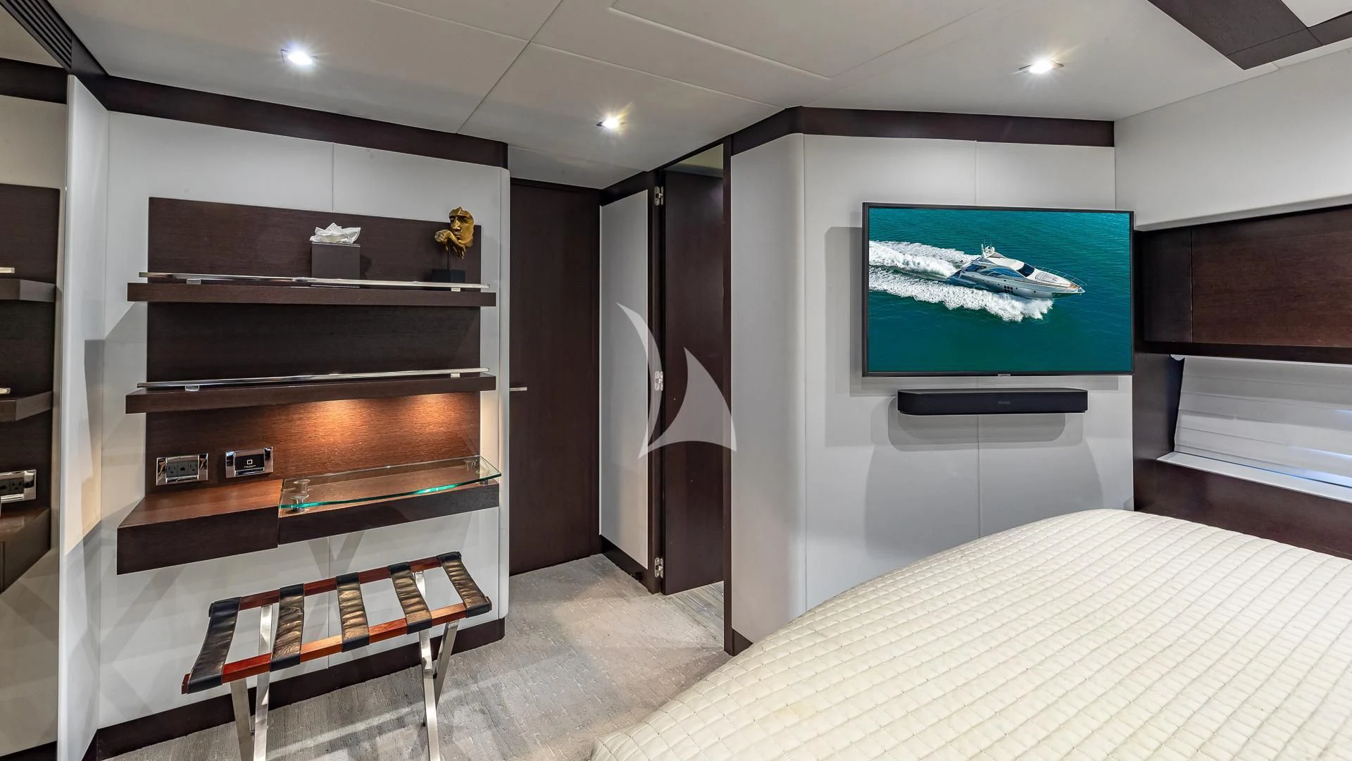 a room with a bed and a television aboard M Yacht for Charter