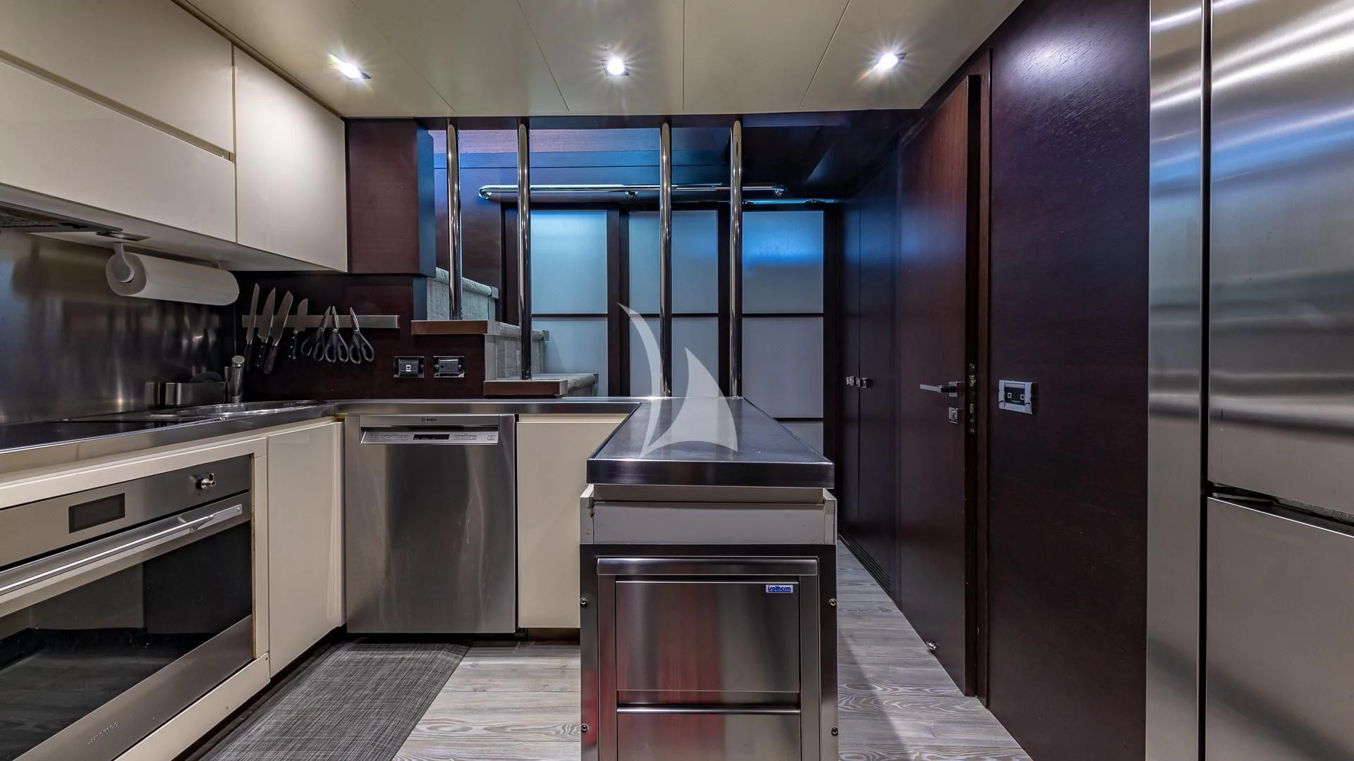 a kitchen with stainless steel appliances aboard M Yacht for Charter