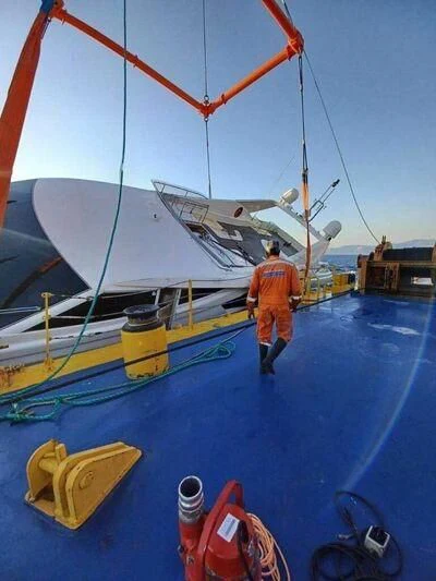 a person standing next to a sailboat aboard GREEN WHISPER Yacht for Sale