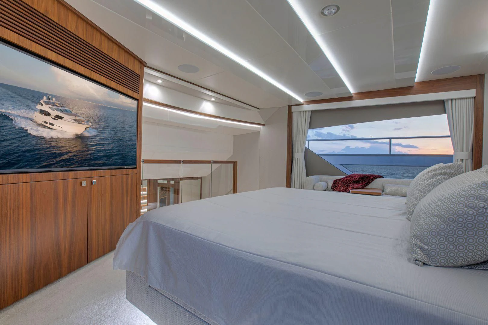 a bedroom with a bed and a window aboard JUST ONE MORE Yacht for Sale