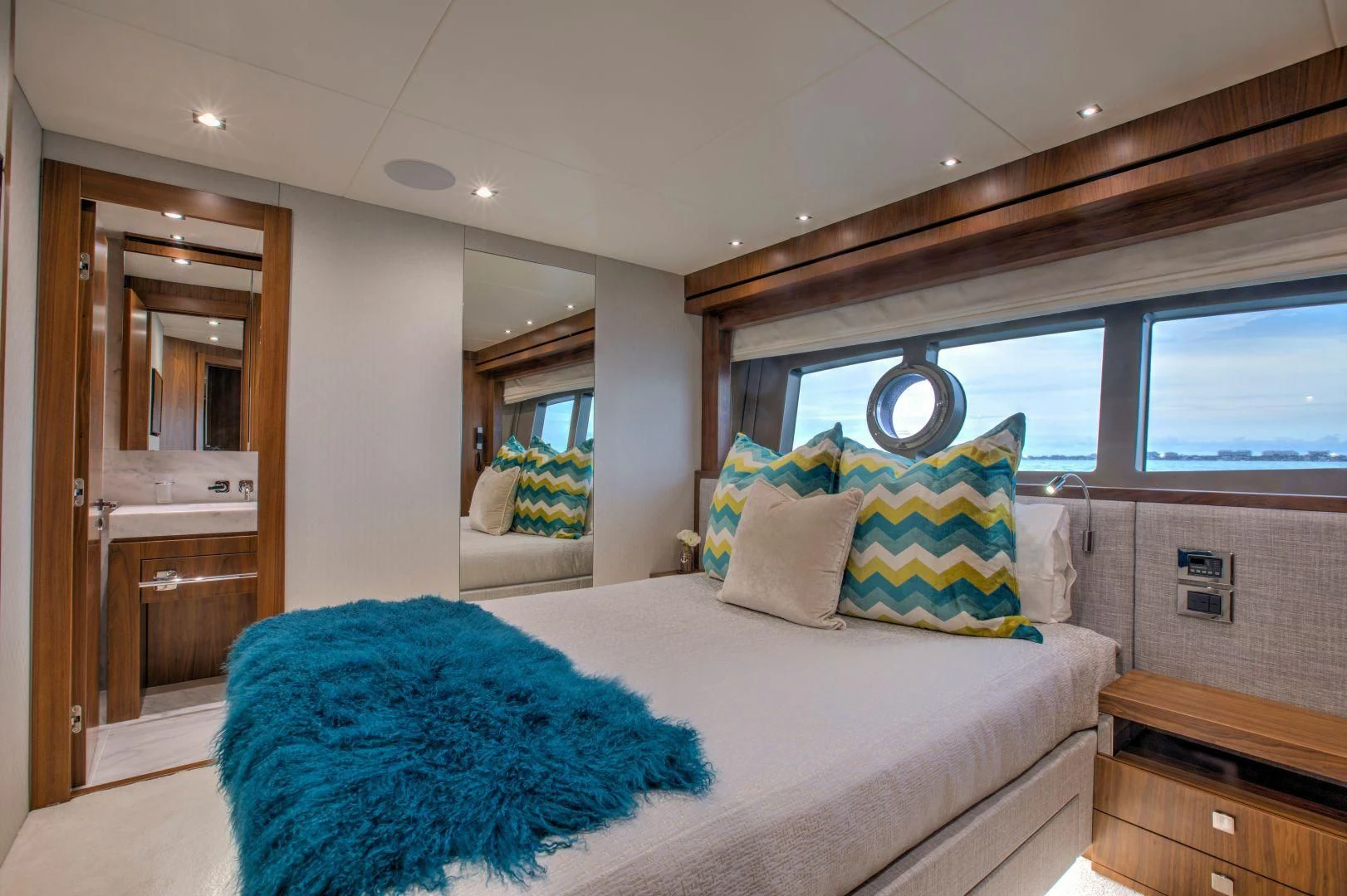 a bedroom with a bed and a mirror aboard JUST ONE MORE Yacht for Sale
