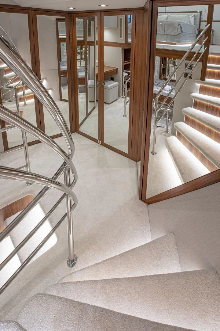 a set of stairs leading to a room with glass doors aboard JUST ONE MORE Yacht for Sale