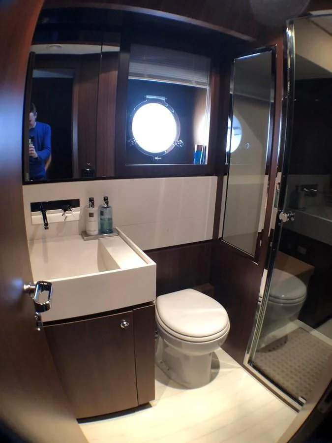 a bathroom with a toilet and a sink aboard MANISCO Yacht for Sale