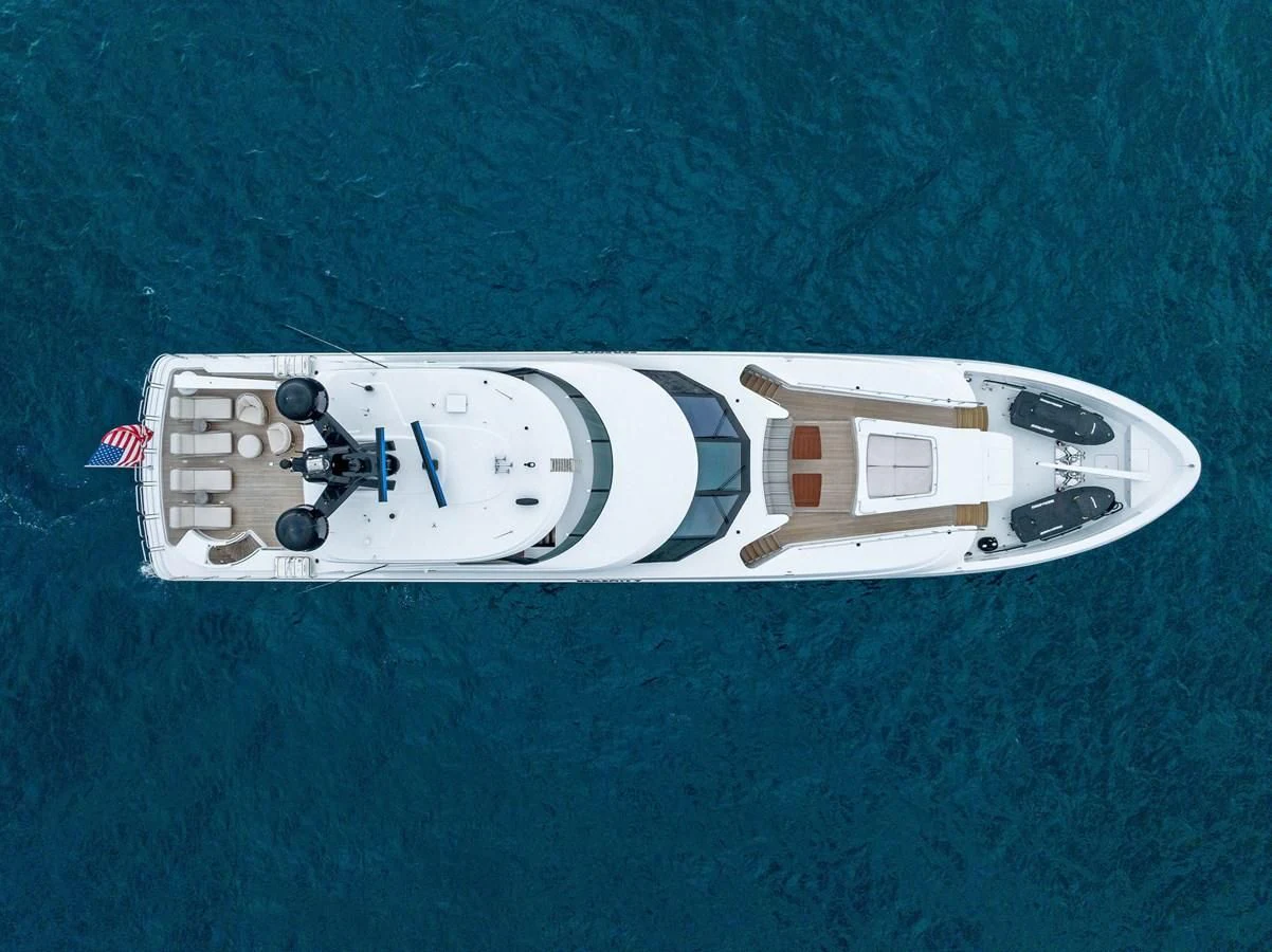 a white boat on a blue surface aboard SERENITY Yacht for Sale