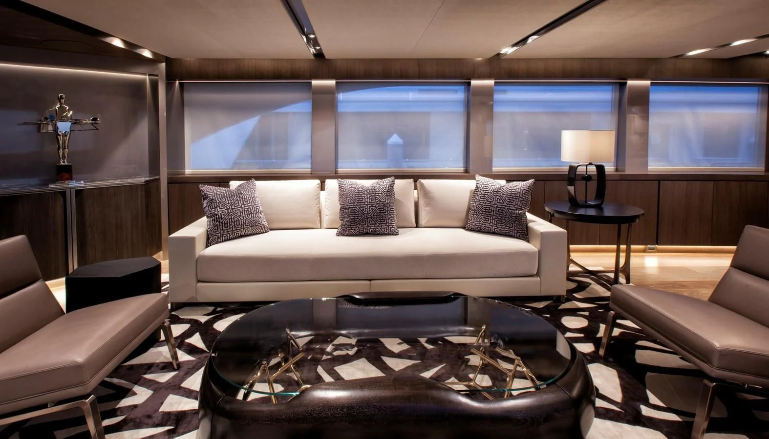 a living room with a large white couch and a large window aboard SERENITY Yacht for Sale