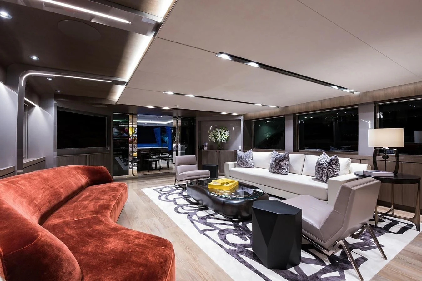 a living room with a large screen aboard SERENITY Yacht for Sale