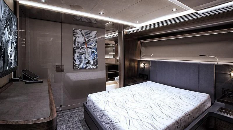 a room with a bed and a painting on the wall aboard SERENITY Yacht for Sale
