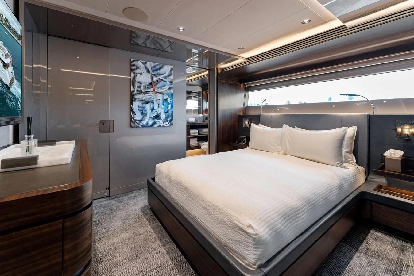 a bedroom with a bed and a tv aboard SERENITY Yacht for Sale