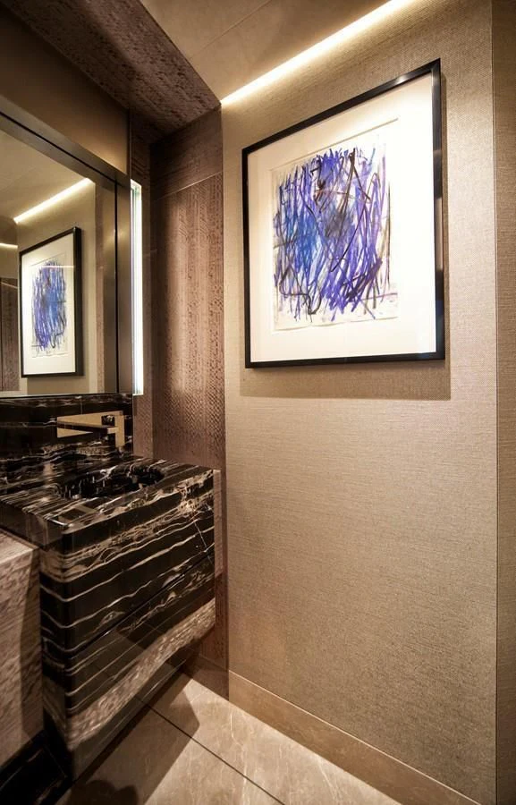 a room with a painting on the wall aboard SERENITY Yacht for Sale