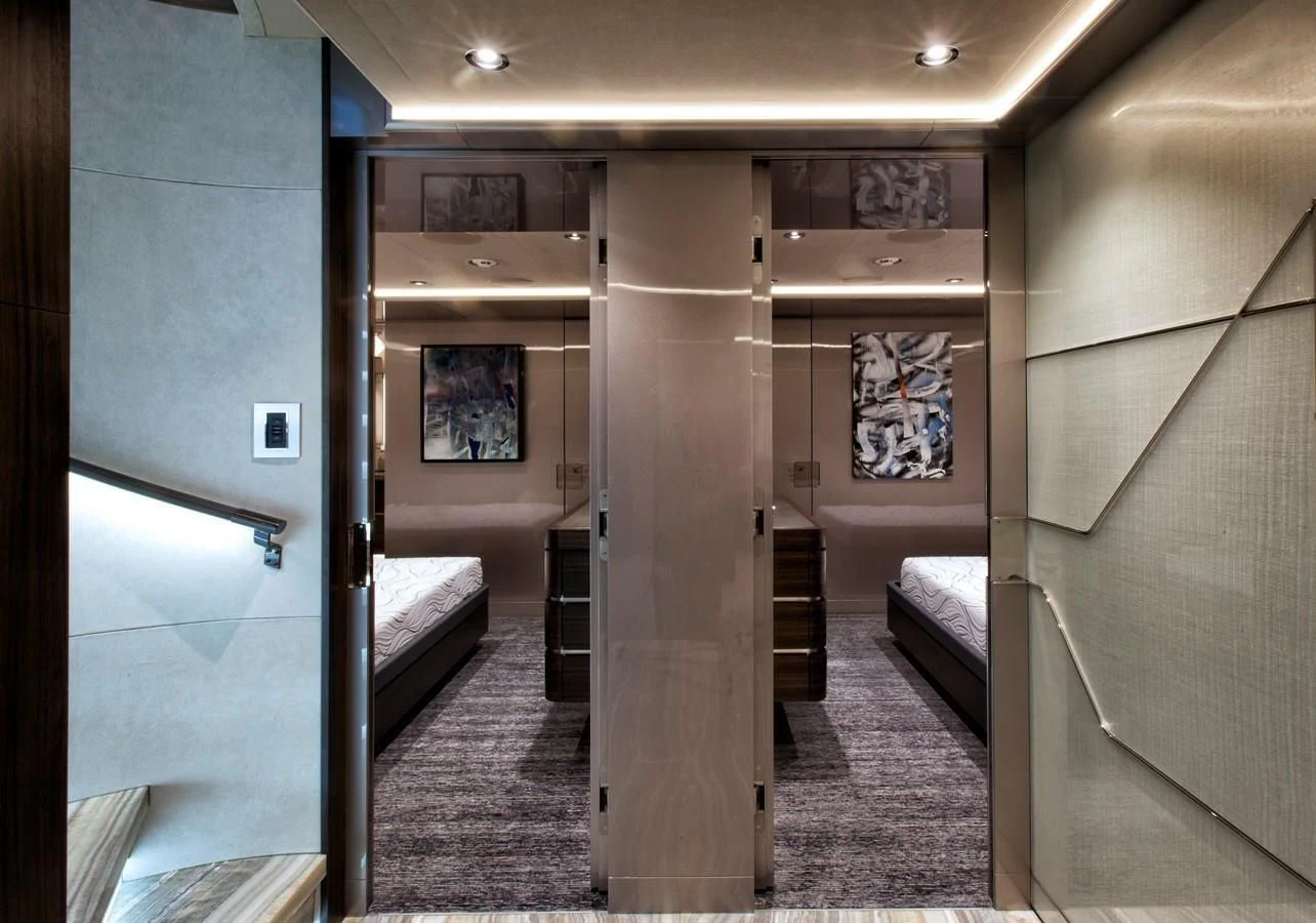 a hallway with a bed and a door aboard SERENITY Yacht for Sale