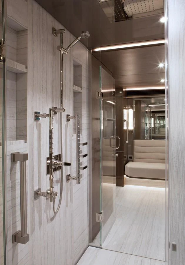 a bathroom with a glass shower aboard SERENITY Yacht for Sale