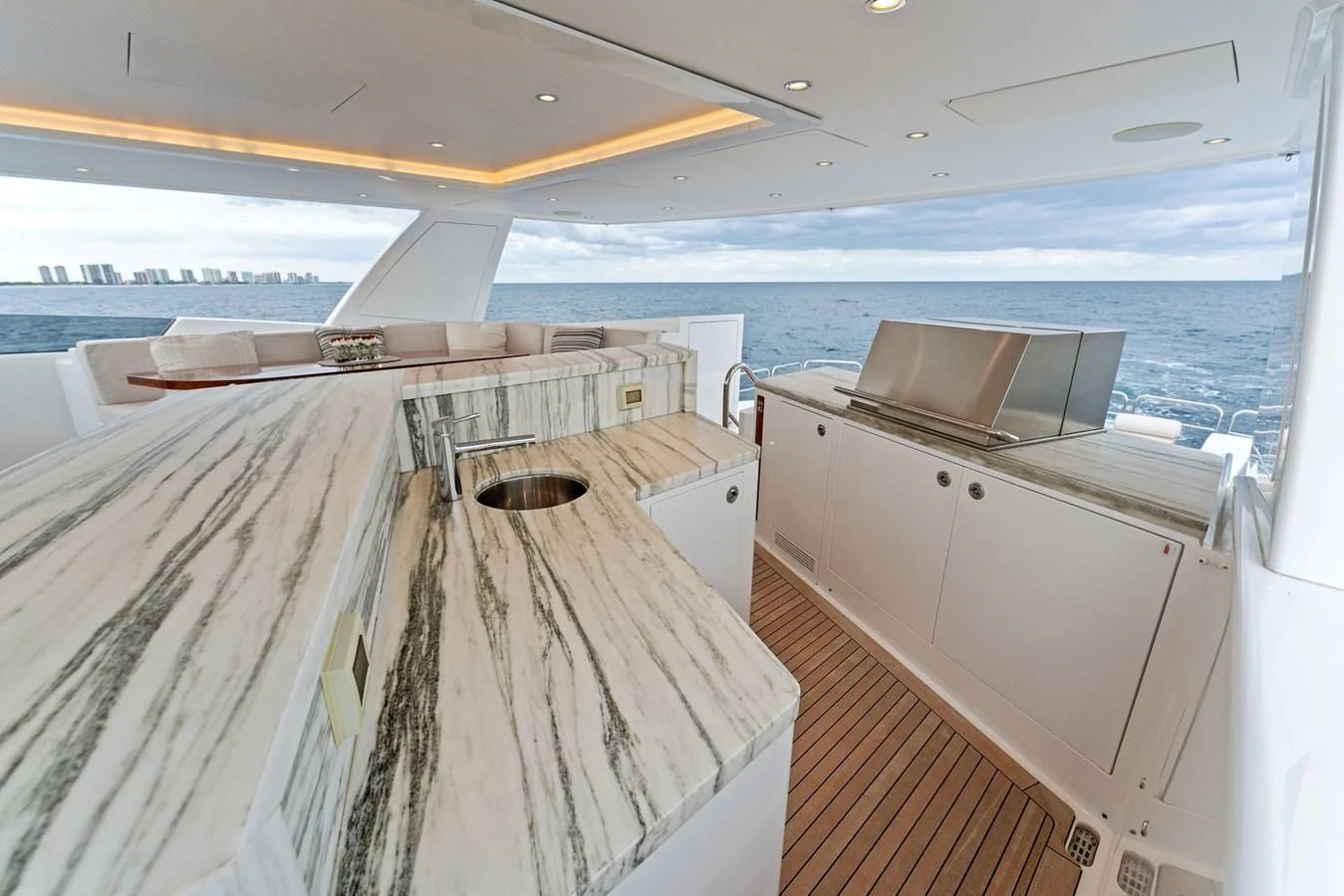 a boat with a sink and a large boat in the water aboard SERENITY Yacht for Sale