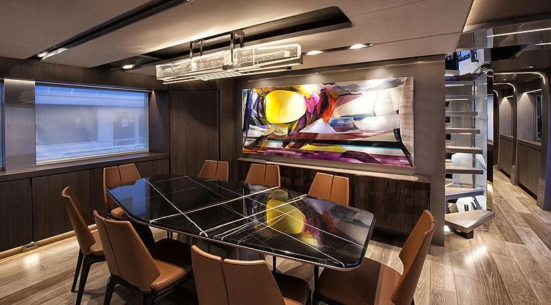 a room with a table and chairs aboard SERENITY Yacht for Sale