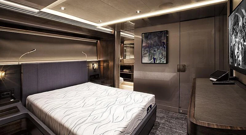 a room with a bed and a desk aboard SERENITY Yacht for Sale