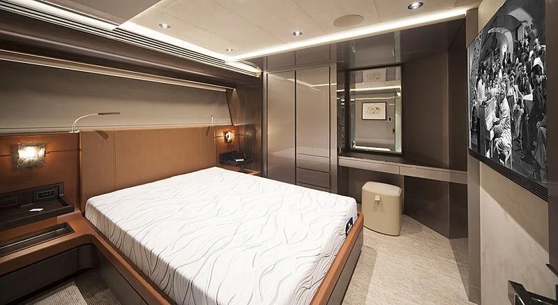 a room with a bed and a piano aboard SERENITY Yacht for Sale