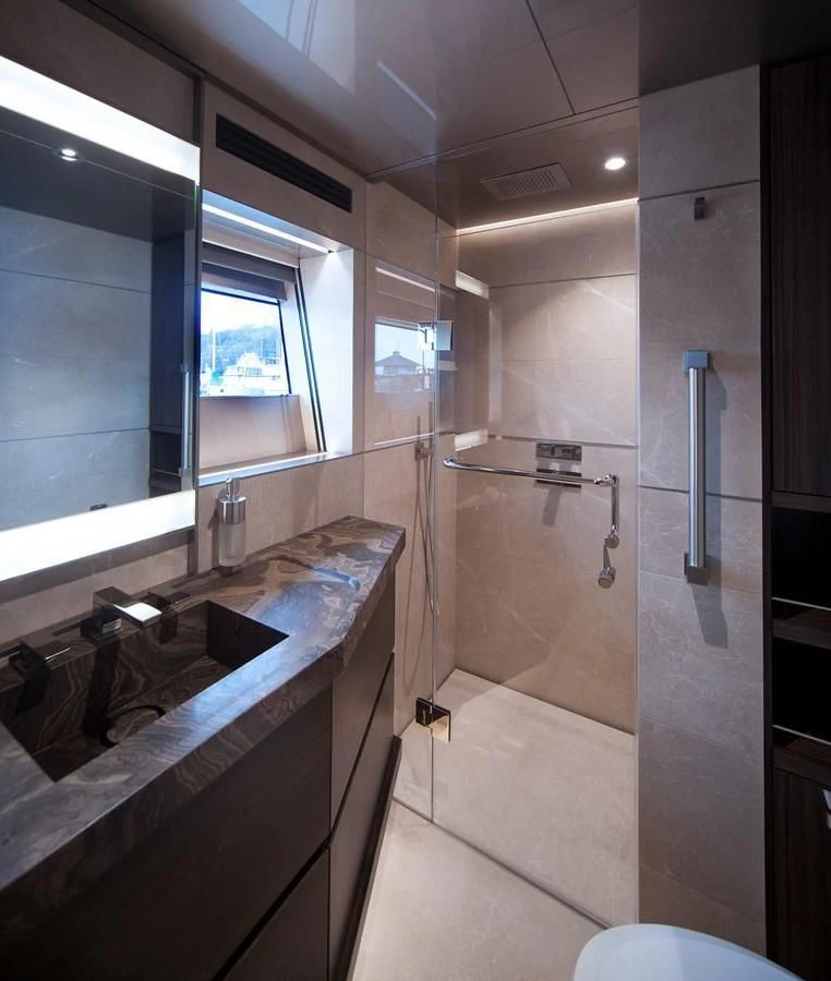 a bathroom with a sink and a mirror aboard SERENITY Yacht for Sale