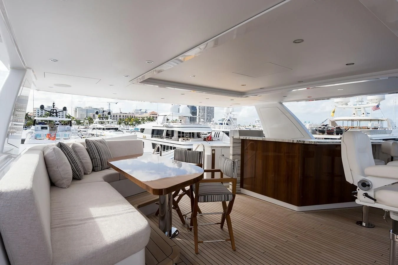 a room with a couch and a table and chairs aboard SERENITY Yacht for Sale