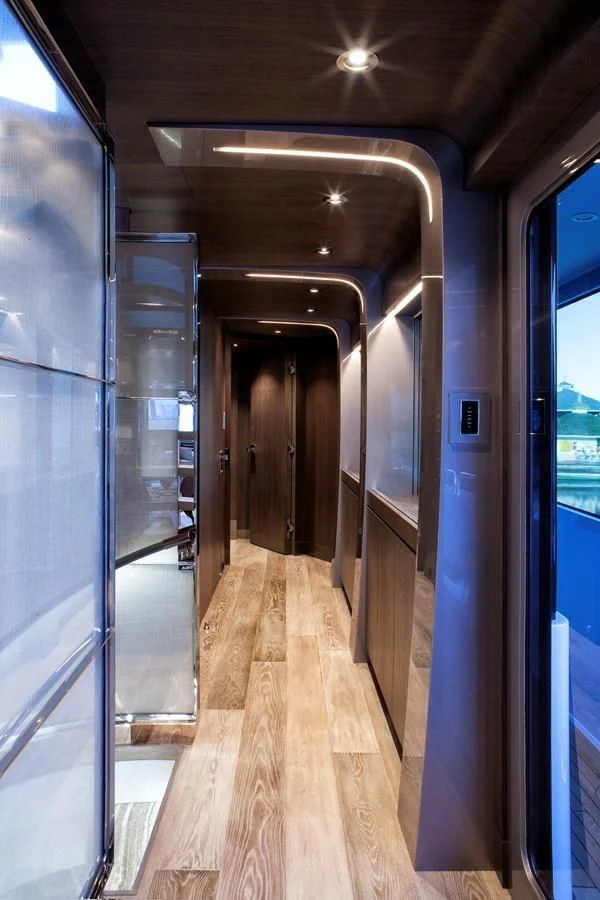 a long hallway with blue doors aboard SERENITY Yacht for Sale