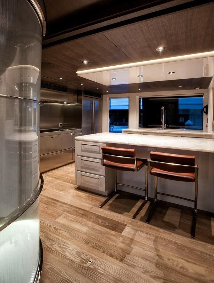 a kitchen with a table and chairs aboard SERENITY Yacht for Sale