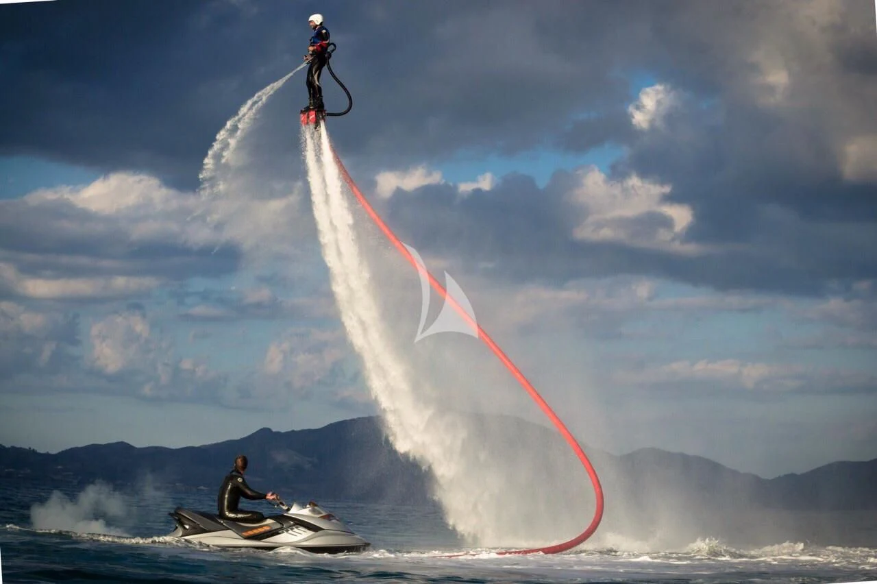 a person jumping off a ski aboard DRAGON Yacht for Sale