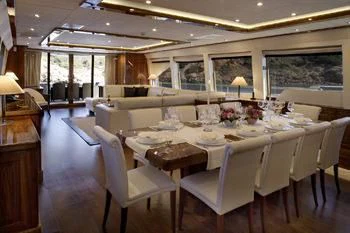a large room with tables and chairs aboard DRAGON Yacht for Sale