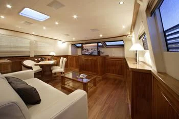 a room with a couch and a table and chairs aboard DRAGON Yacht for Sale