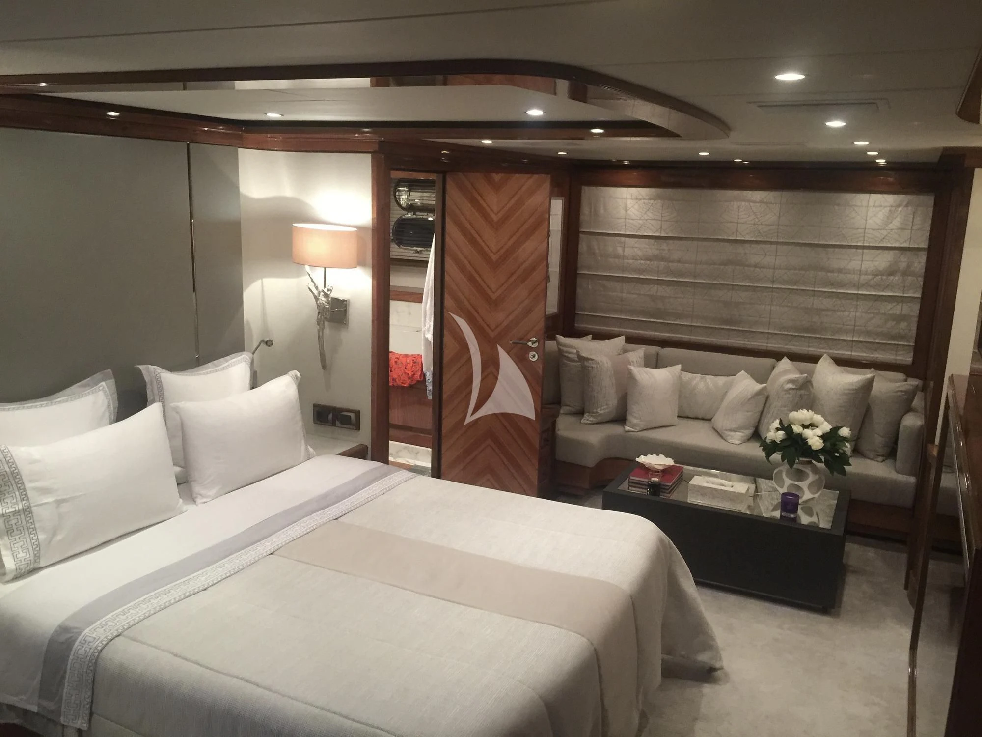 a room with a bed and a couch aboard DRAGON Yacht for Sale