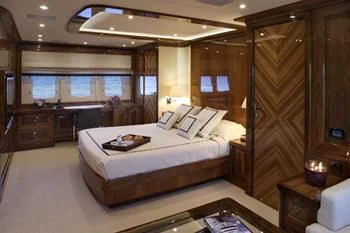 a room with a bed and a table aboard DRAGON Yacht for Sale