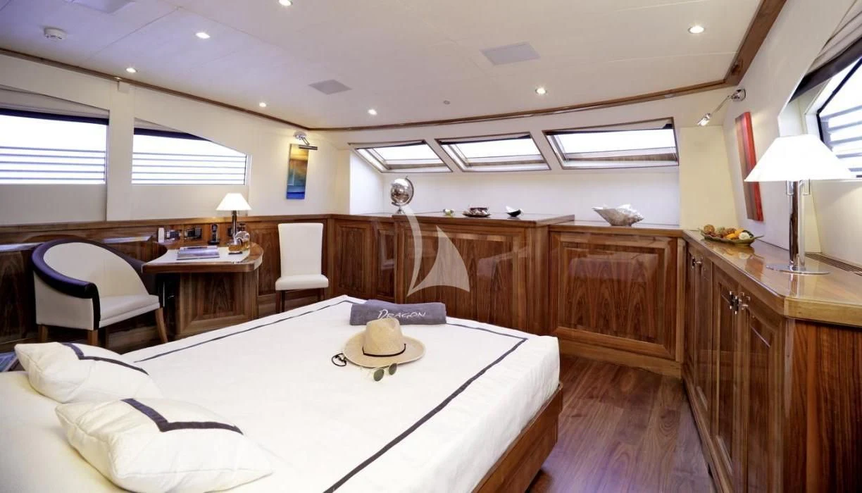 a large bedroom with a large bed aboard DRAGON Yacht for Sale