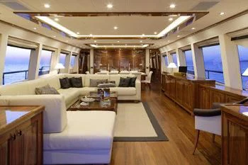 a living room with a couch and a table aboard DRAGON Yacht for Sale