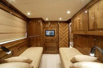 a room with a bed and a television aboard DRAGON Yacht for Sale