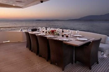 a table with wine glasses on it aboard DRAGON Yacht for Sale