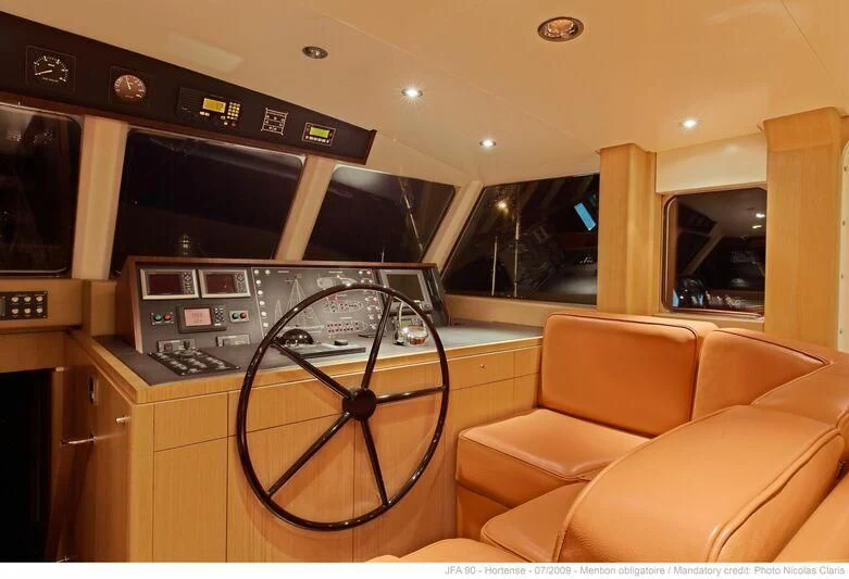a room with a couch and a television aboard HORTENSE Yacht for Sale