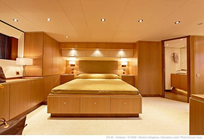 a large room with a bed aboard HORTENSE Yacht for Sale