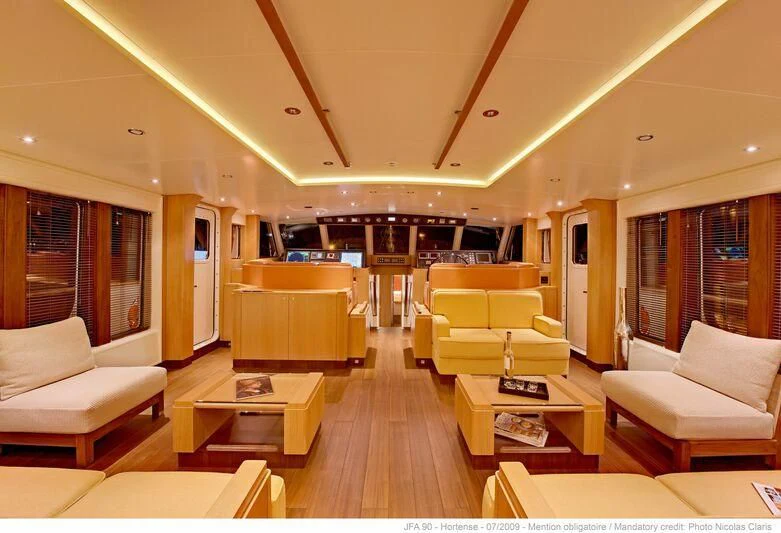 a living room with a wood floor aboard HORTENSE Yacht for Sale