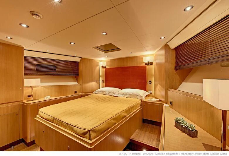 a room with a bed and a desk aboard HORTENSE Yacht for Sale