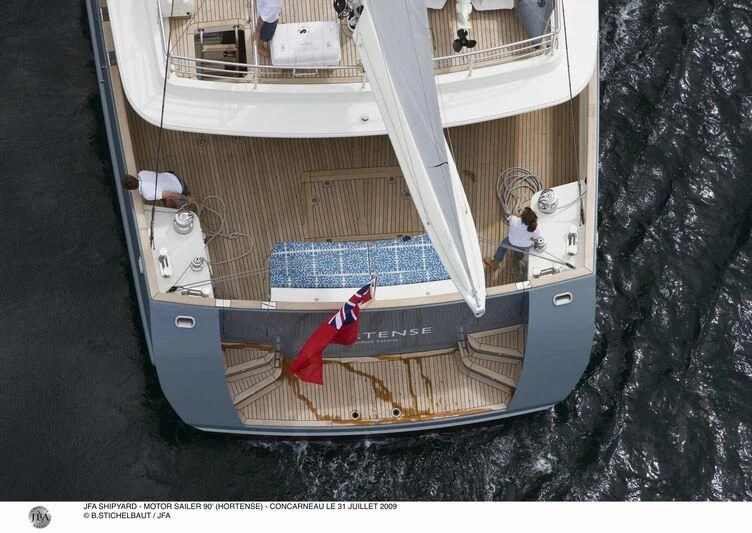 a person sitting on a balcony aboard HORTENSE Yacht for Sale