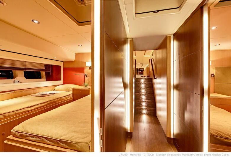 a room with a bed and a closet aboard HORTENSE Yacht for Sale