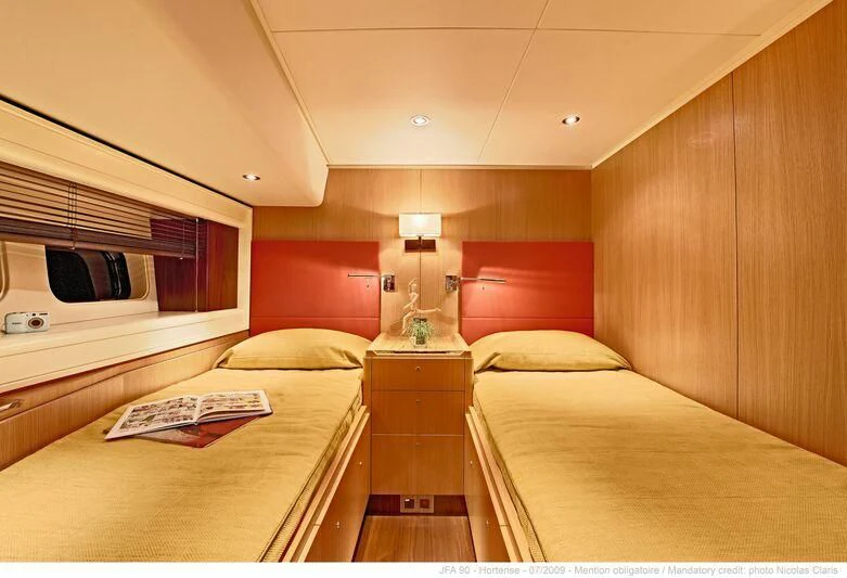 a room with a bed and a television aboard HORTENSE Yacht for Sale