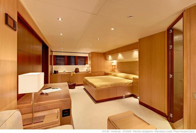 a room with a bed and a desk aboard HORTENSE Yacht for Sale